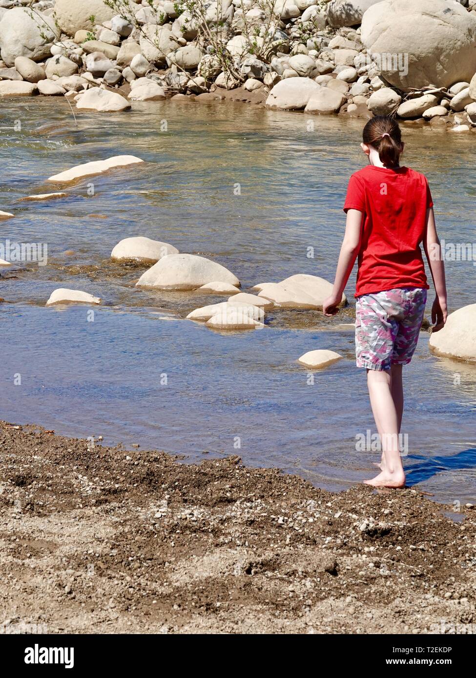 Twelve year old girl playing by the Ventura River in Ojai, California, USA Stock Photo