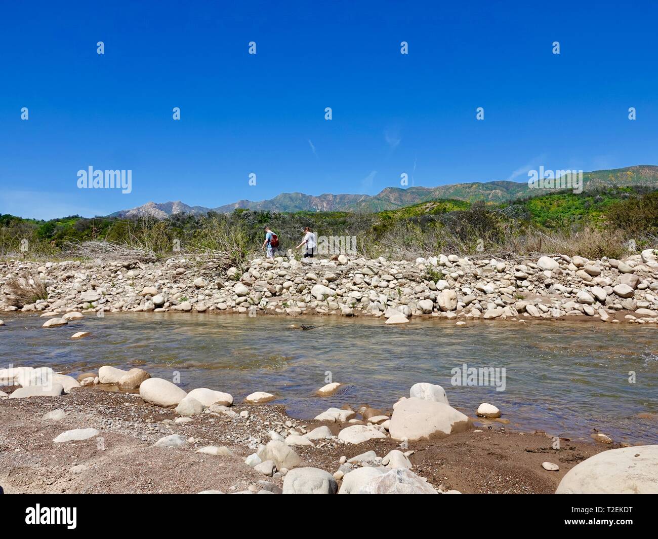 Young couple hiking on a path beside the Ventura River, Ojai