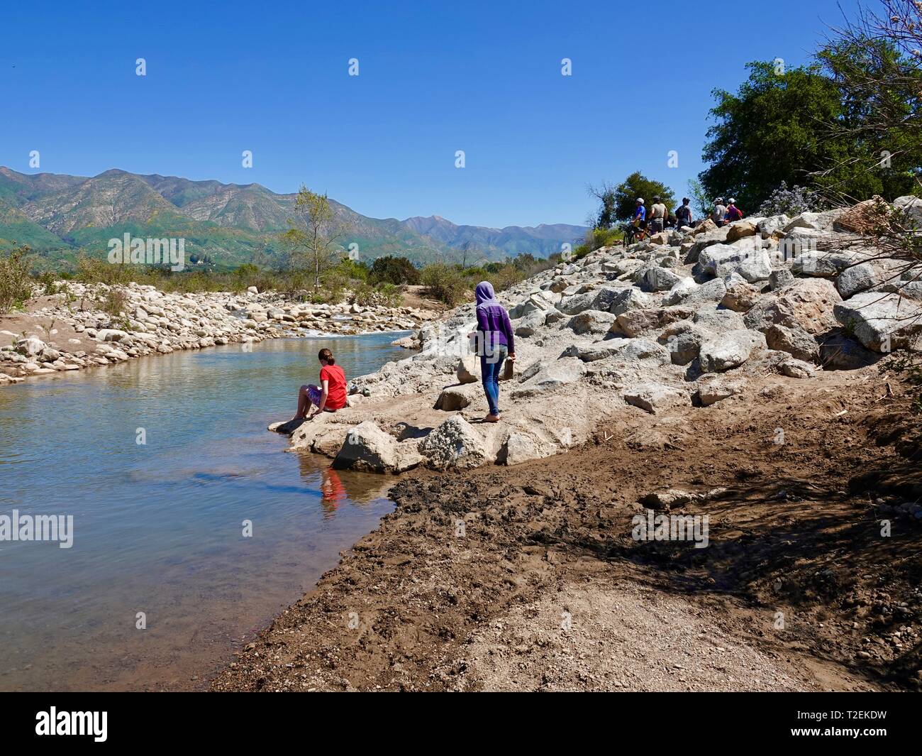Two preteen sisters playing by the Ventura River with mountain biking