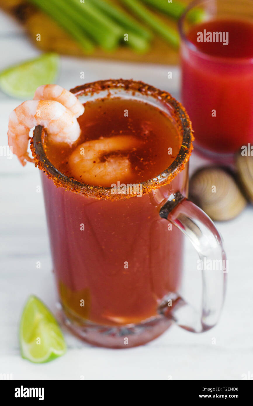 Michelada beer with tomato juice, clam and lemon, mexican drink