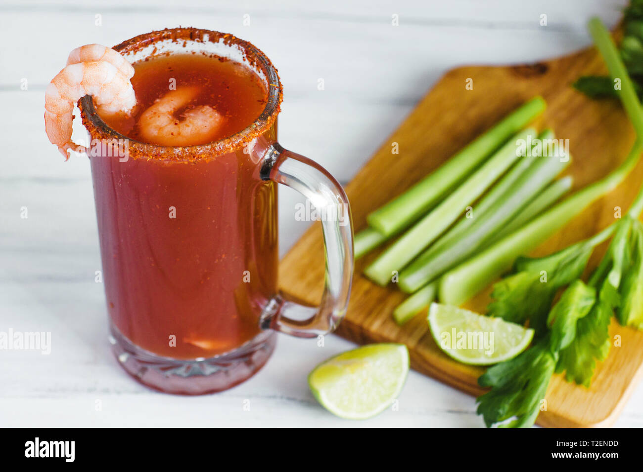 Michelada beer with tomato juice, clam and lemon, mexican drink