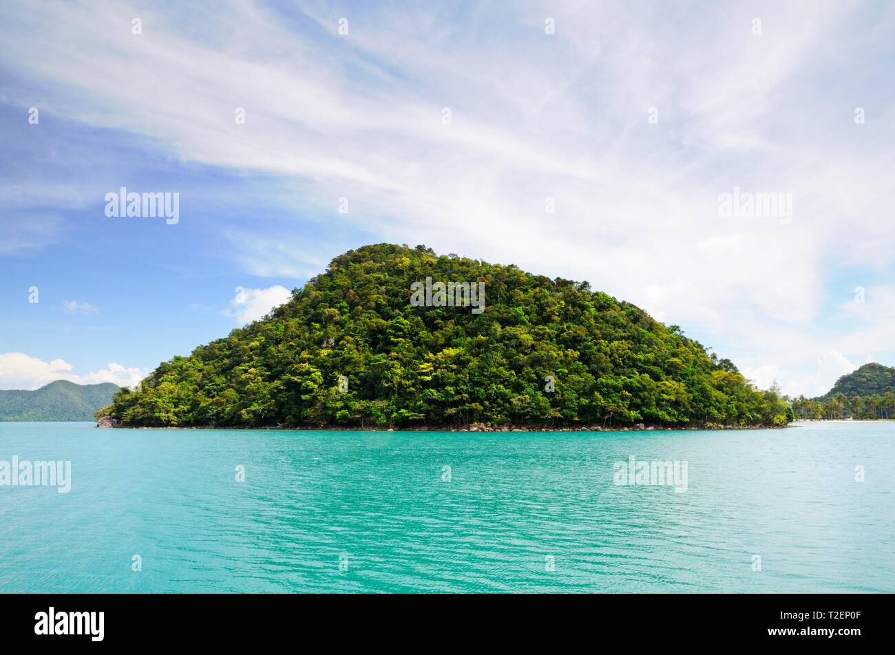 Tropical island in turquoise sea with mountain covered with rainforest at the Koh Chang island, Thailand. Stock Photo
