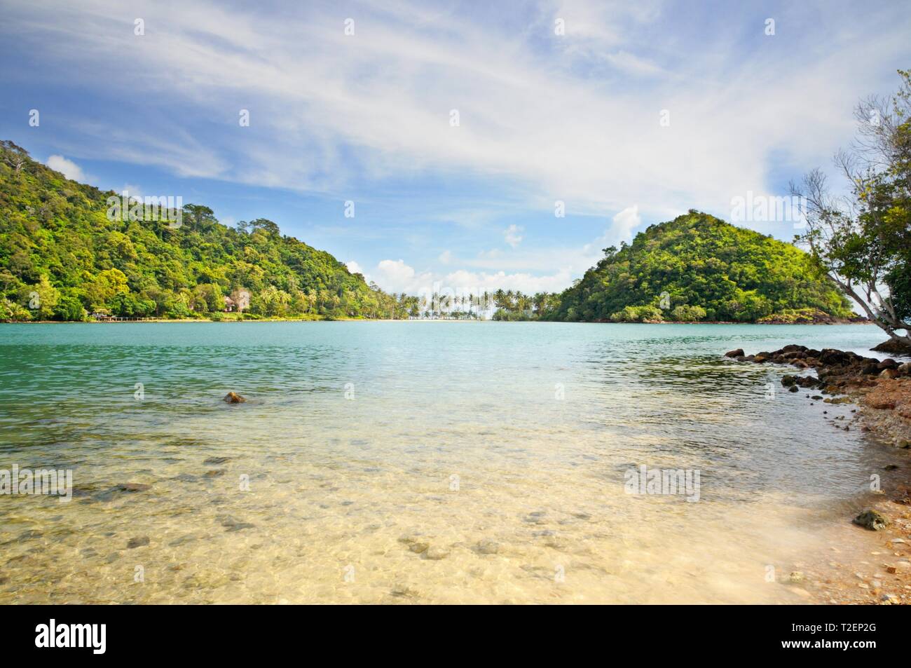 Crystal clear tropical sea with island covered with rainforest on horizon at the Koh Chang island, Thailand. Stock Photo