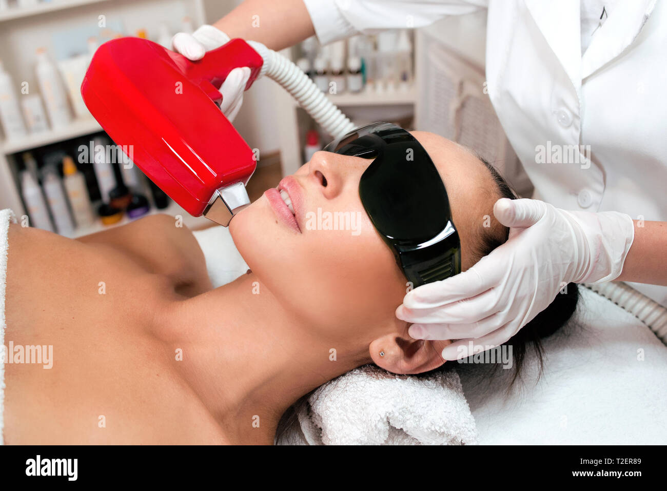 Beautiful woman face on laser hair removal at epilation cabinet Stock Photo  - Alamy