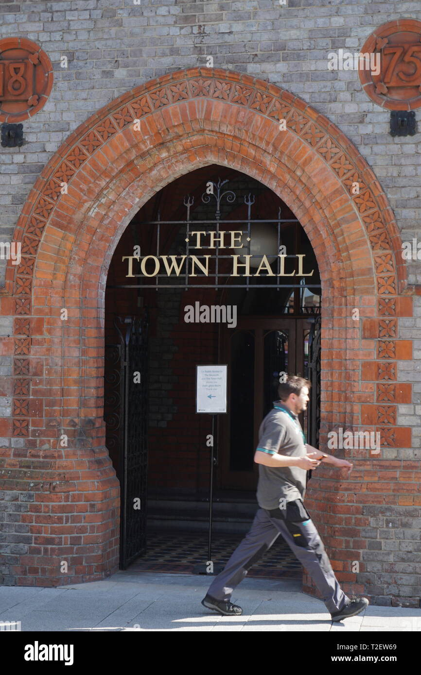 A man passes the entrance to The Town Hall, Reading, Berkshire, UK Stock Photo