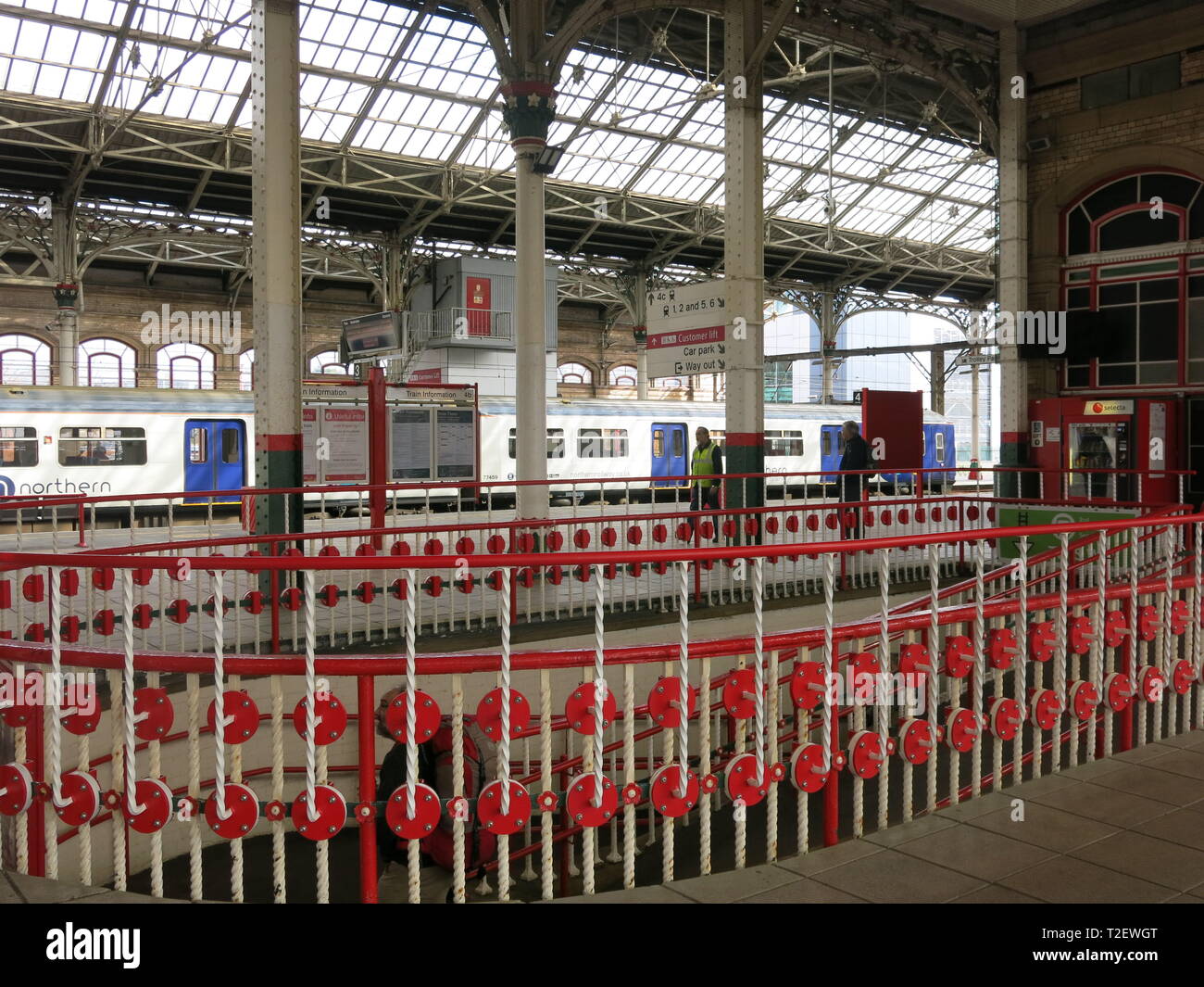 View of Preston railway station showing Victorian architecture, ornate ironwork, glazed roof, platforms and trains. Stock Photo
