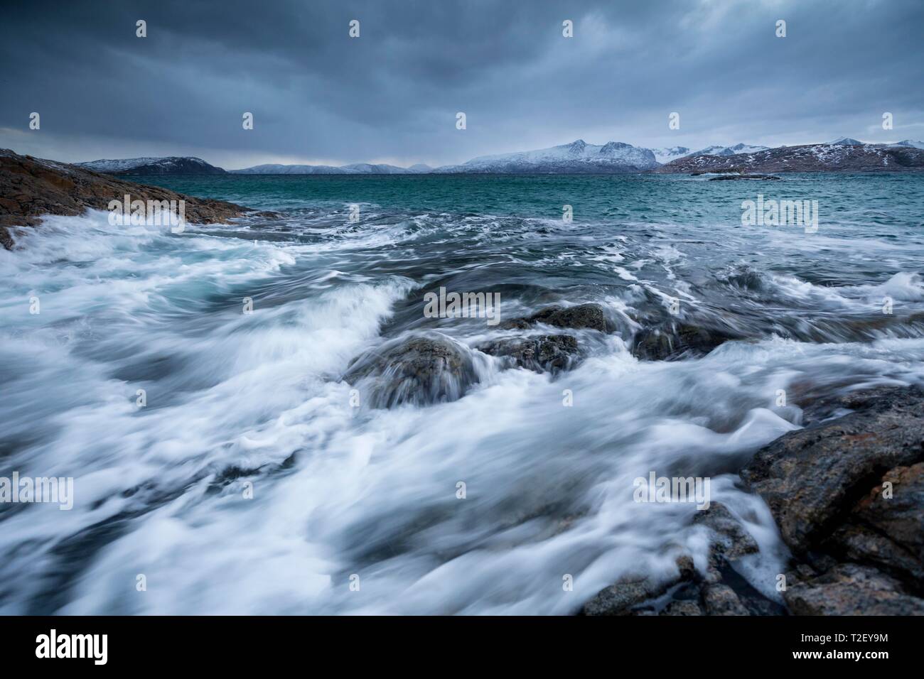 Dark clouds over the stormy sea, coastal landscape in winter, island Sommaroy, Hillsoya, Tromso, Troms, Norway Stock Photo