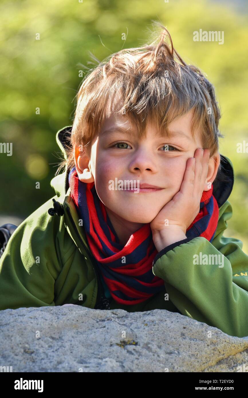 Portrait of a little boy, head resting on stone, Argentina Stock Photo