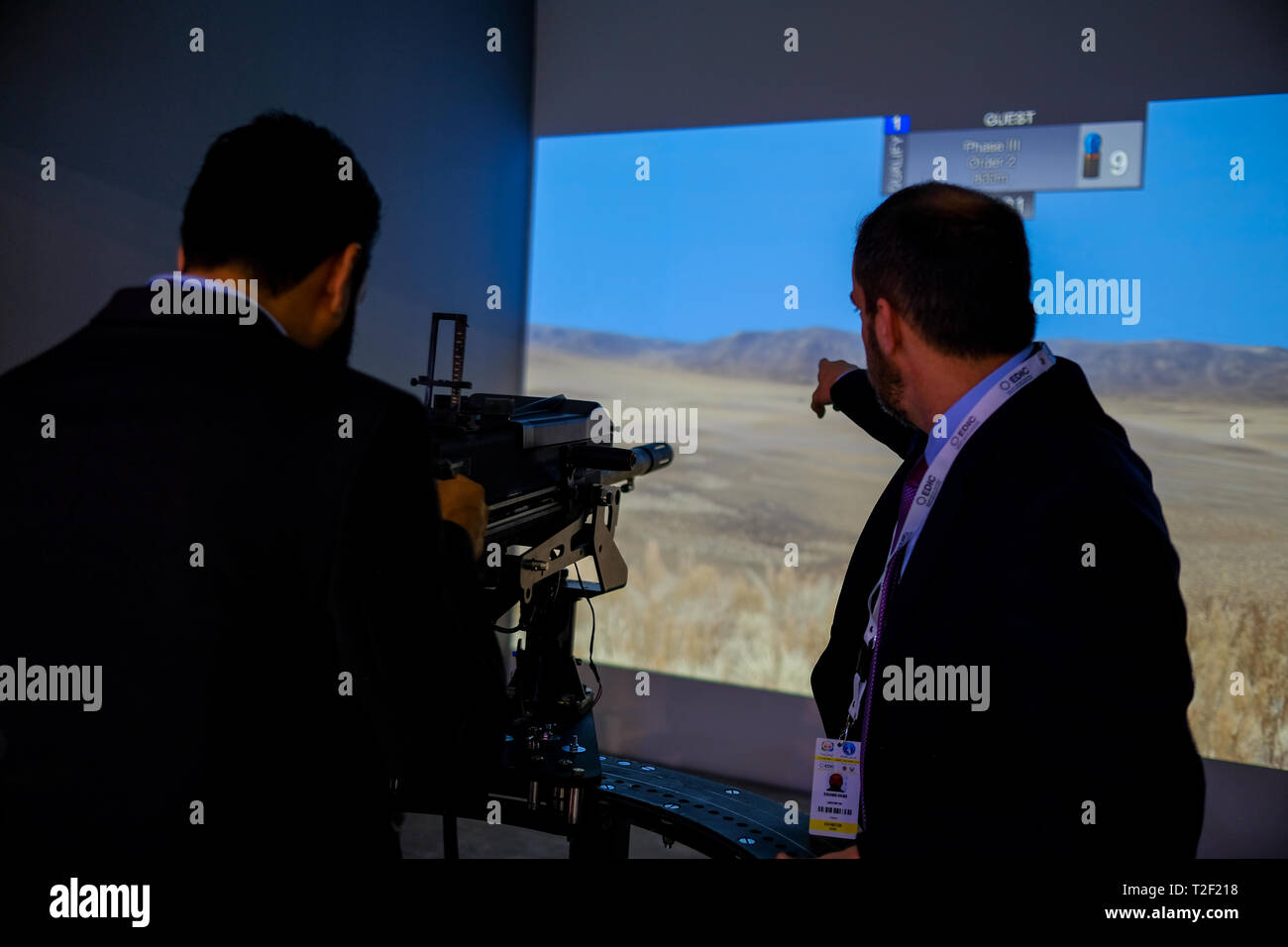 February 18, 2019 - Abu Dhabi, UAE: Instructor of Gun simulator display pointing at aim Stock Photo