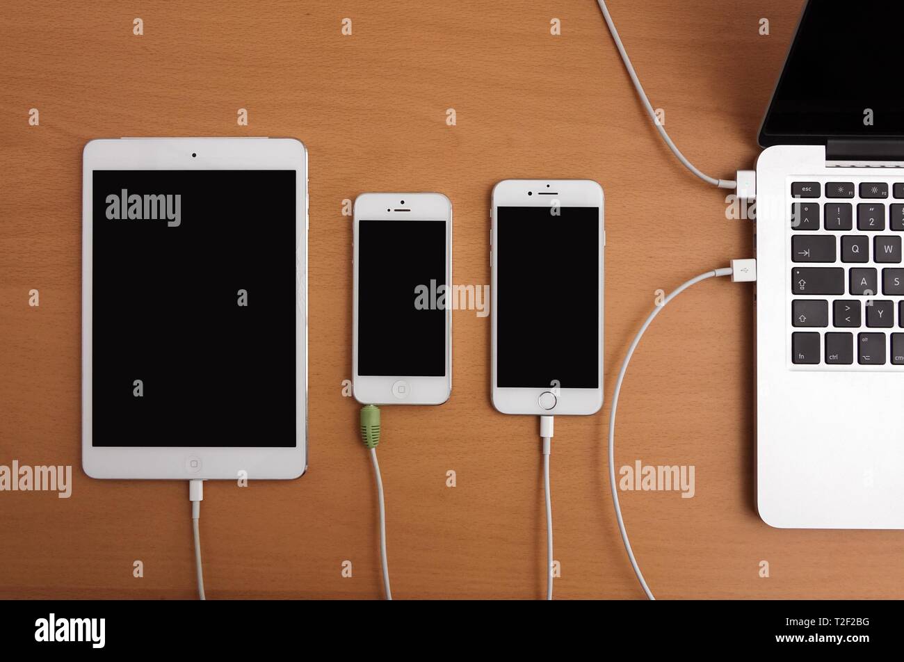Apple mobile devices, computers, screens black, charging, Germany Stock