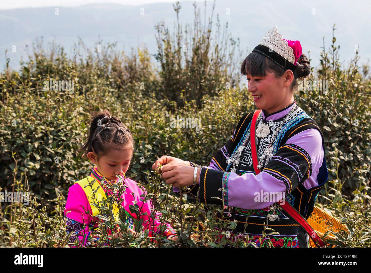 Yi Woman Yiliang, China - March 24, 2019: Black Yi woman and her daughter ...
