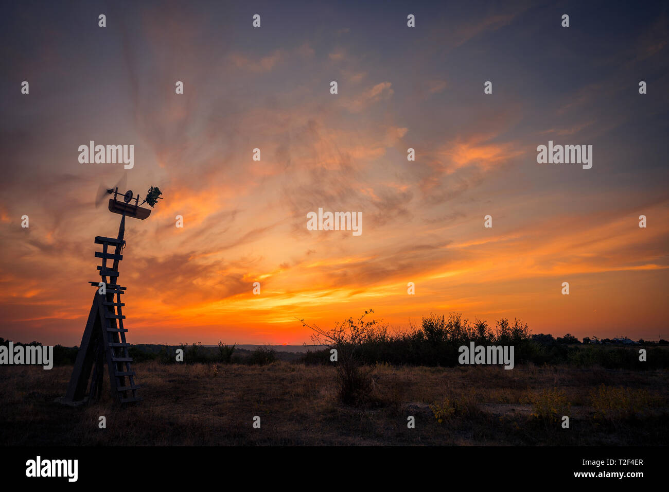 Handmade wooden spinner against sunset  spinning in the wind Stock Photo