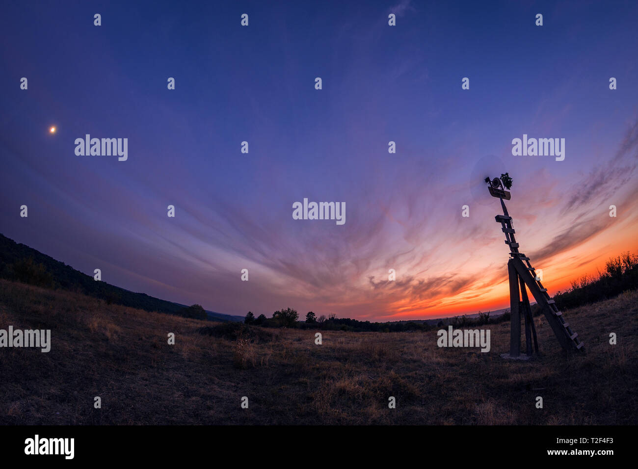 Handmade wooden spinner against sunset  spinning in the wind Stock Photo