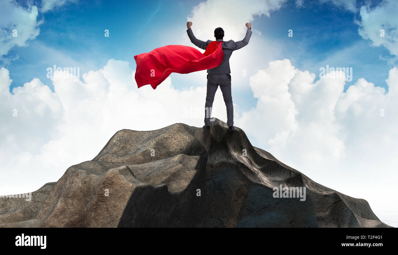 Superhero businessman on top of mountain Stock Photo - Alamy
