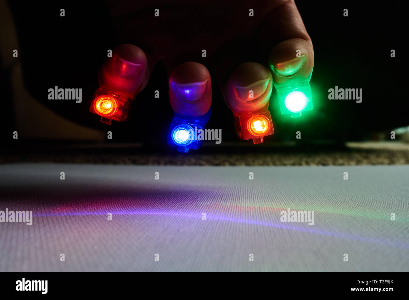 multi-color finger lights on outstretched hand Stock Photo - Alamy