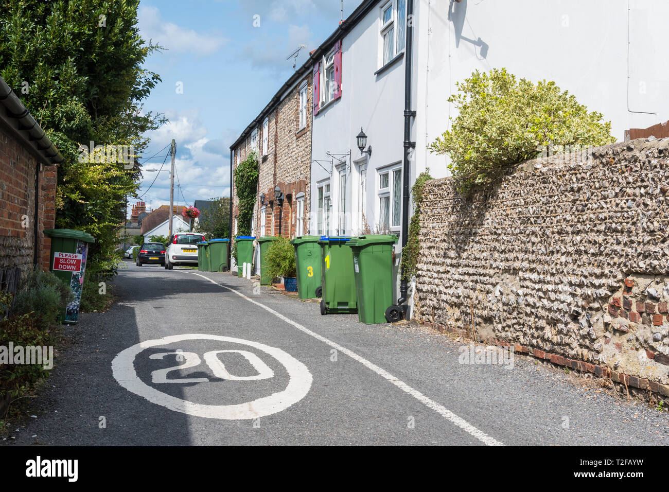 20MPH speed restriction sign painted in a narrow road in a British town in Upper Beeding, West Sussex, UK. 20MPH speed limit in a narrow street. Stock Photo