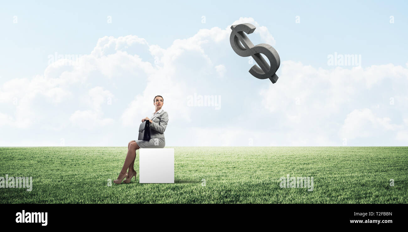 Elegant businesswoman with suitcase in hand sitting on white cube and ...