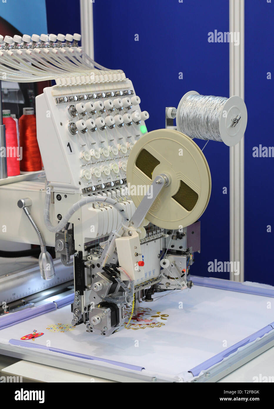 Textile manufacture. The machine embroiders a floral pattern. Factory ...