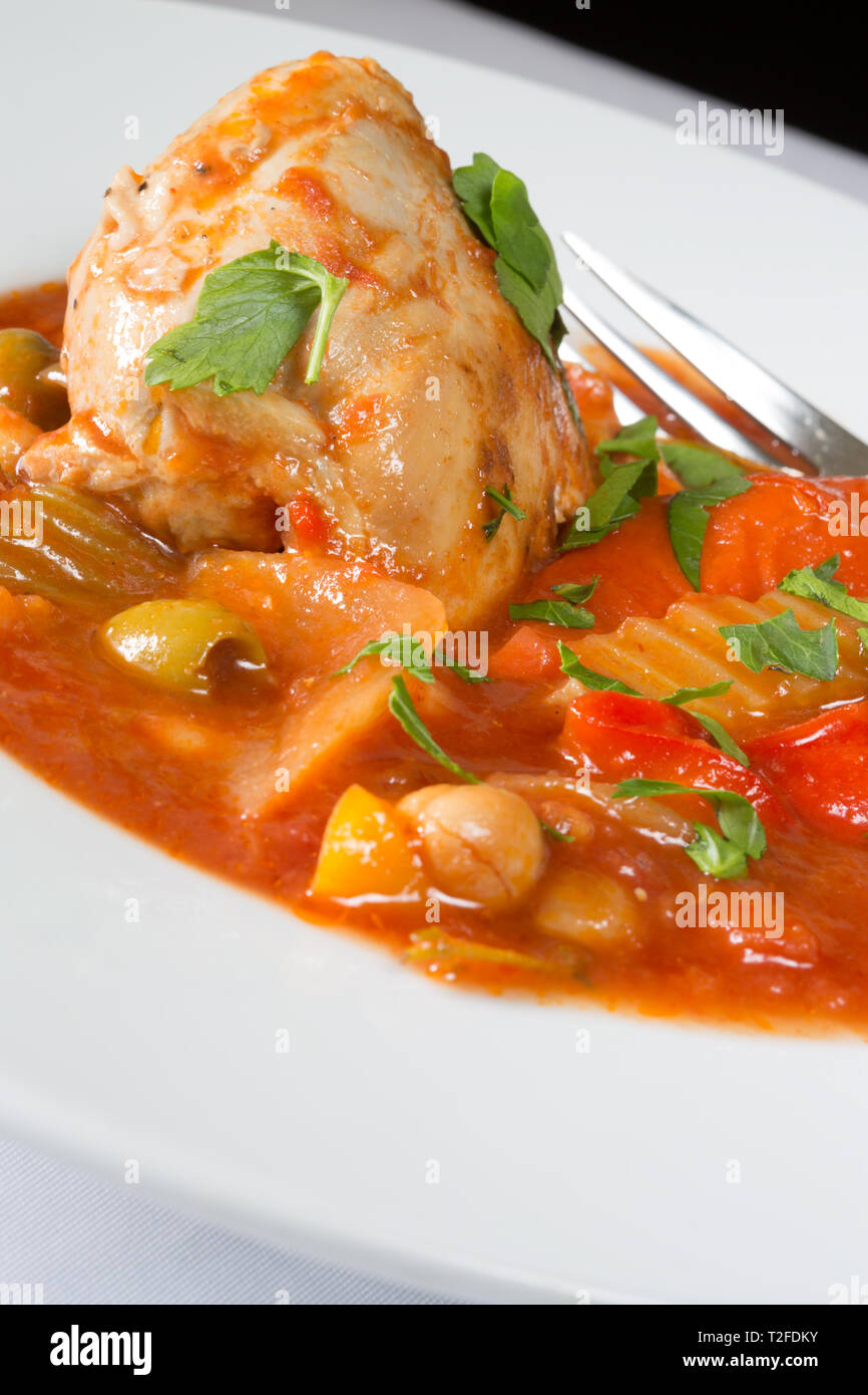 A plated dish of Spanish Chicken, Red pepper and olive stew Stock Photo