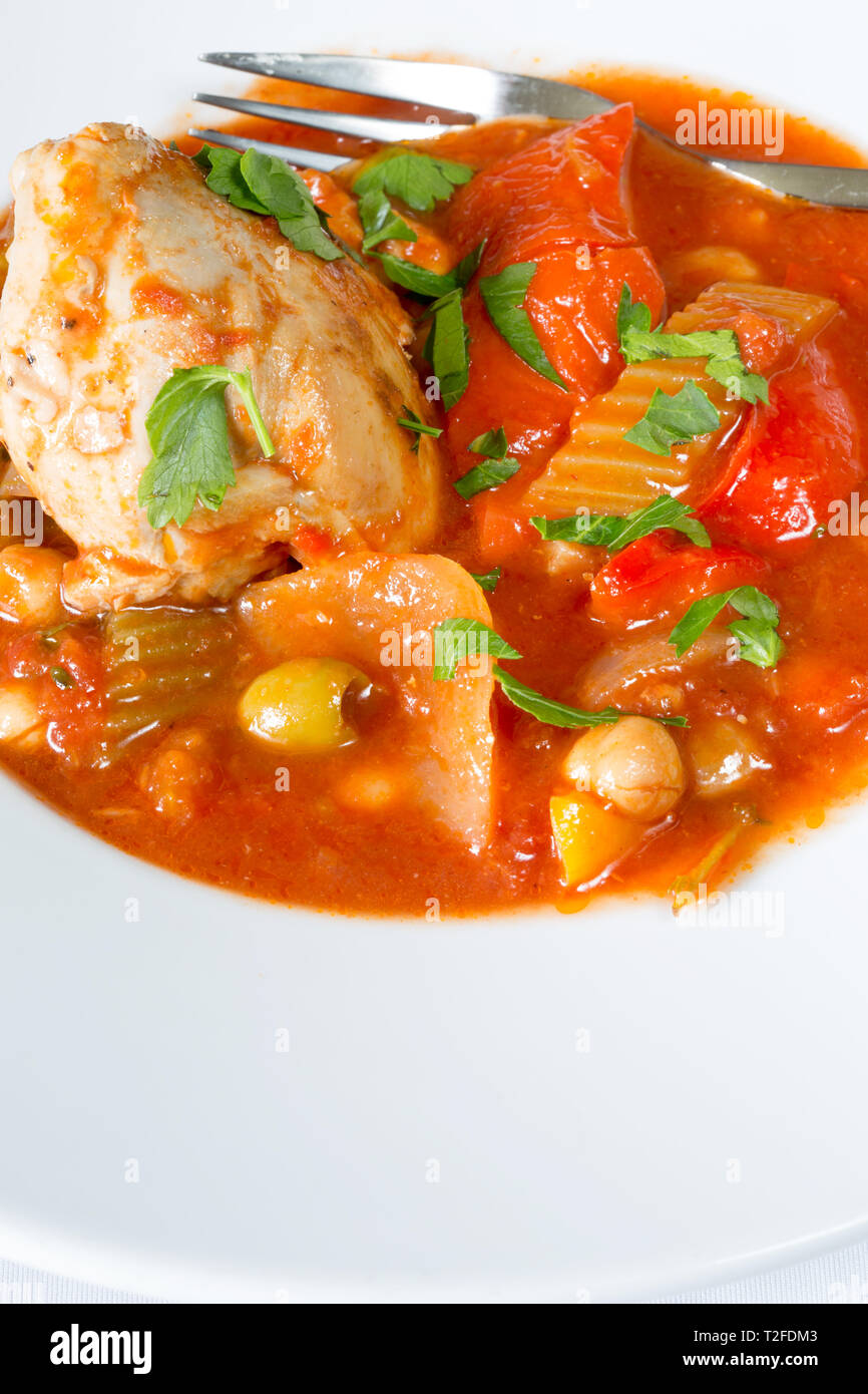A plated dish of Spanish Chicken, Red pepper and olive stew Stock Photo