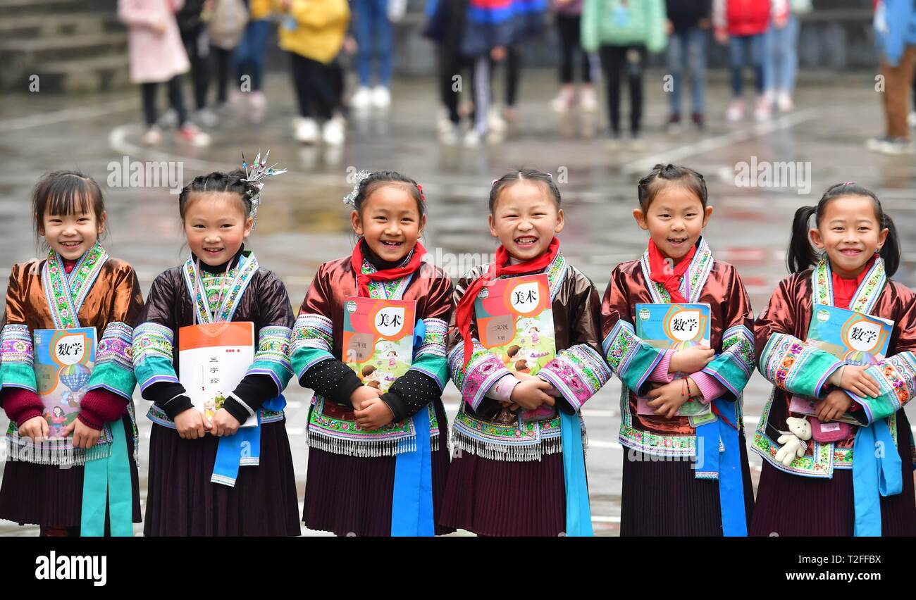 (190402) -- BEIJING, April 2, 2019 (Xinhua) -- Students pose for a group photo at the central school in Gandong Township in Miao Autonomous County of Rongshui, south China's Guangxi Zhuang Autonomous Region, March 14, 2019. China's efforts to promote the 'balanced development' of compulsory education, which usually means narrowing inter-regional, rural-urban or inter-school gaps in terms of education conditions and quality, has borne fruit, the Ministry of Education said Tuesday. According to the ministry, the balanced development of compulsory education has been achieved in 2,717 counties Stock Photo