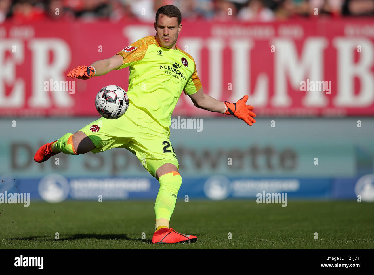 30 March 2019, Bavaria, Nürnberg: Soccer: Bundesliga, 1st FC Nuremberg - FC Augsburg, 27th matchday in Max Morlock Stadium. Nuremberg goalkeeper Christian Mathenia plays the ball. Photo: Daniel Karmann/dpa - IMPORTANT NOTE: In accordance with the requirements of the DFL Deutsche Fußball Liga or the DFB Deutscher Fußball-Bund, it is prohibited to use or have used photographs taken in the stadium and/or the match in the form of sequence images and/or video-like photo sequences. Stock Photo