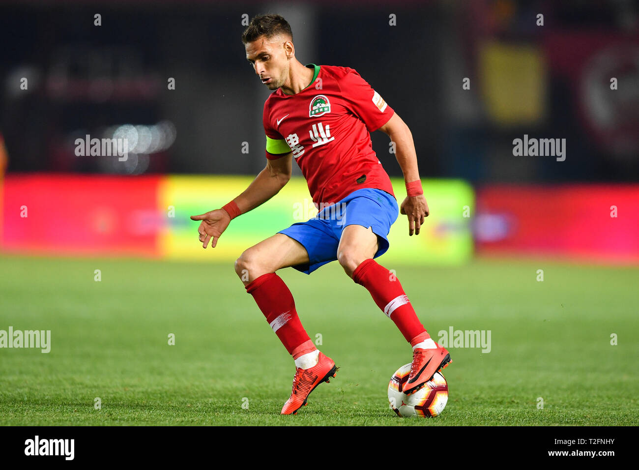 Zhengzhou, China. 31st Mar, 2019. Brazilian football player Olivio da Rosa, also known as Ivo, of Henan Jianye dribbles against Shanghai Greenland Shenhua in their 3rd round match during the 2019 Chinese Football Association Super League (CSL) in Zhengzhou city, central China's Henan province, 31 March 2019. Shanghai Greenland Shenhua defeated Henan Jianye 2-1. Credit: Matt Buxton/Alamy Live News Stock Photo