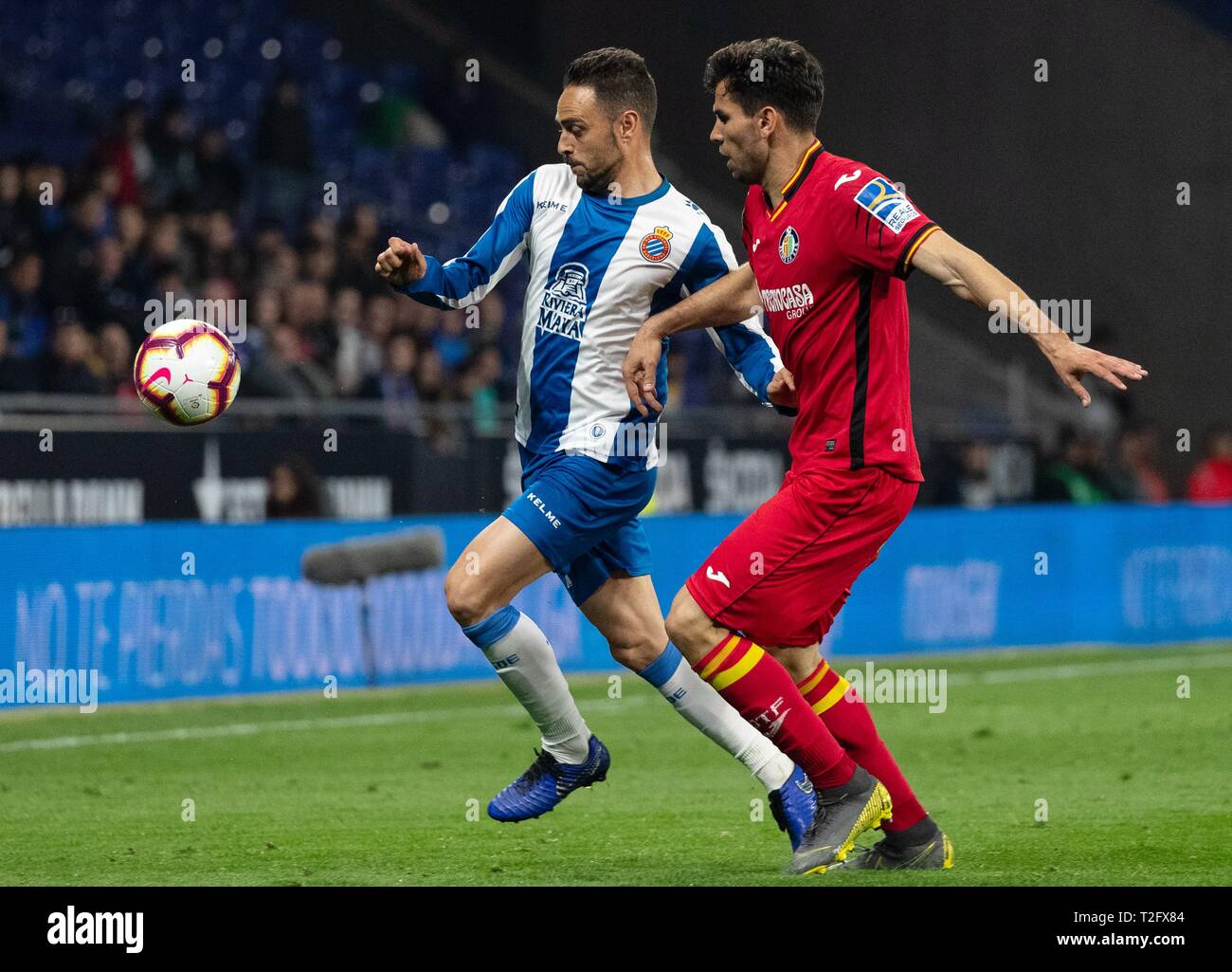 Barcelona, Spain. 2nd Apr, 2019. RCD Espanyol's Sergio Garcia (L) competes with Getafe's Leandro Cabrera during a Spanish league soccer match between RCD Espanyol and Getafe in Barcelona, Spain, on April 2, 2019. The match ended 1-1. Credit: Joan Gosa/Xinhua/Alamy Live News Stock Photo