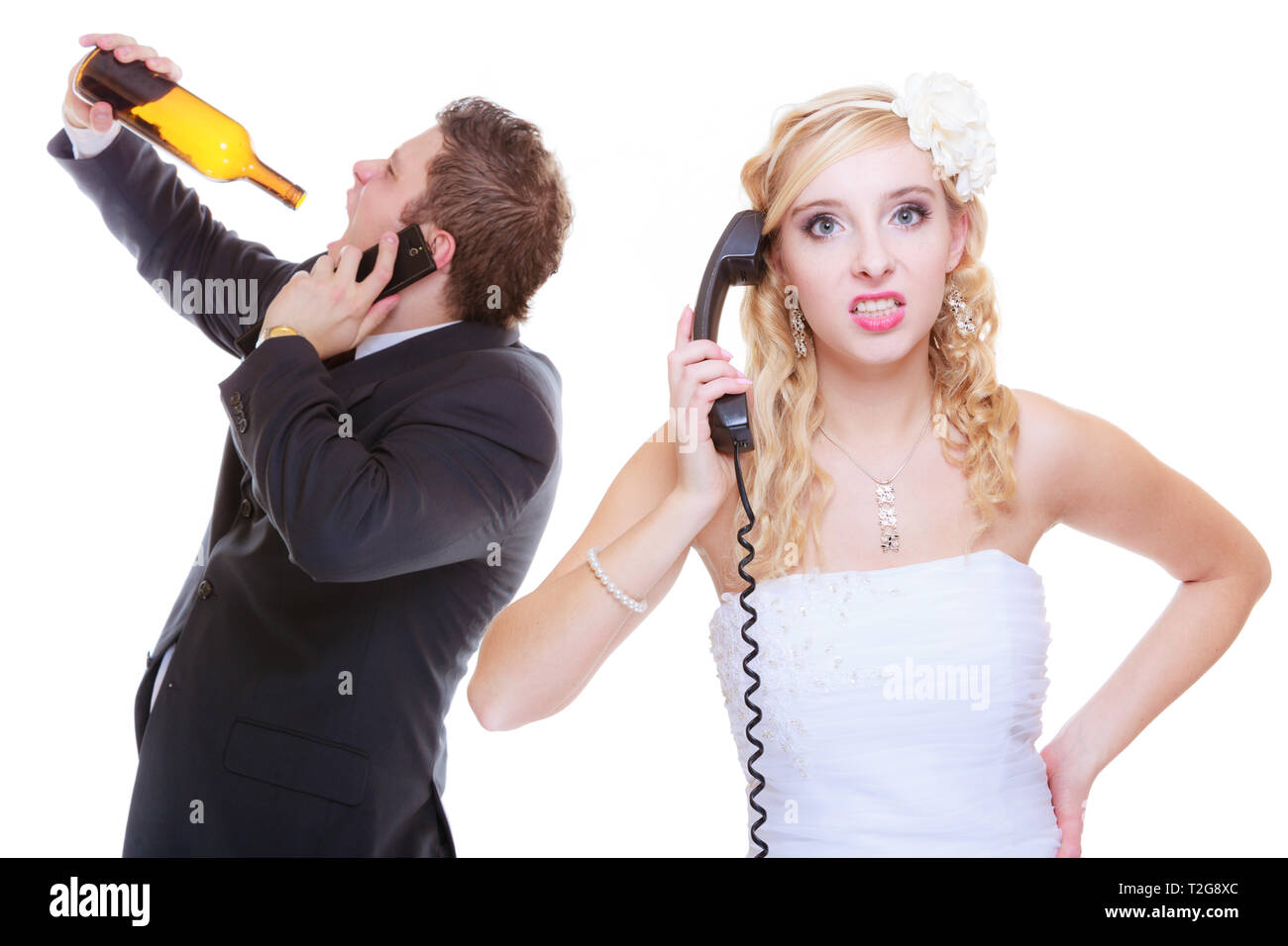Addiction in relationship, marriage problems and troubles concept. Bride having argument with drunk alcoholic groom, she is calling for help Stock Photo