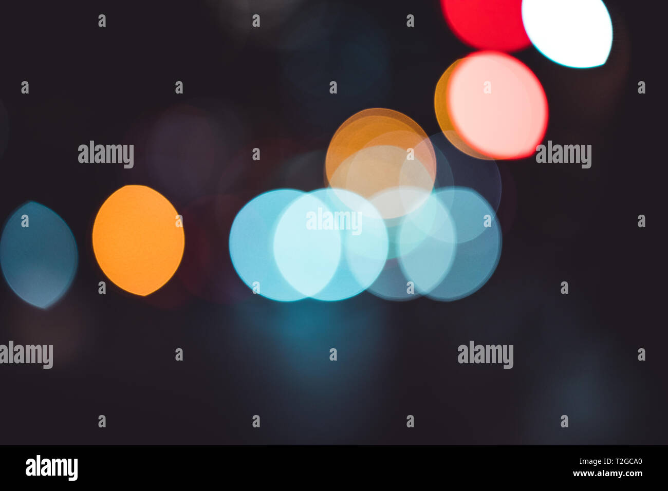 Abstract bokeh lights in city blurred night background Stock Photo
