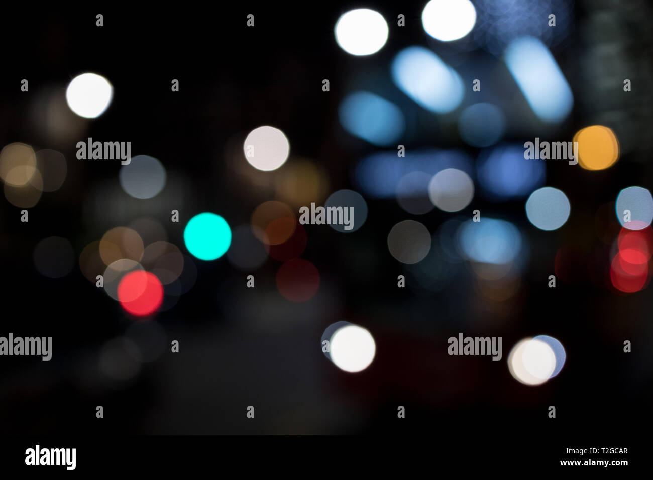 Abstract bokeh lights in city blurred night background Stock Photo