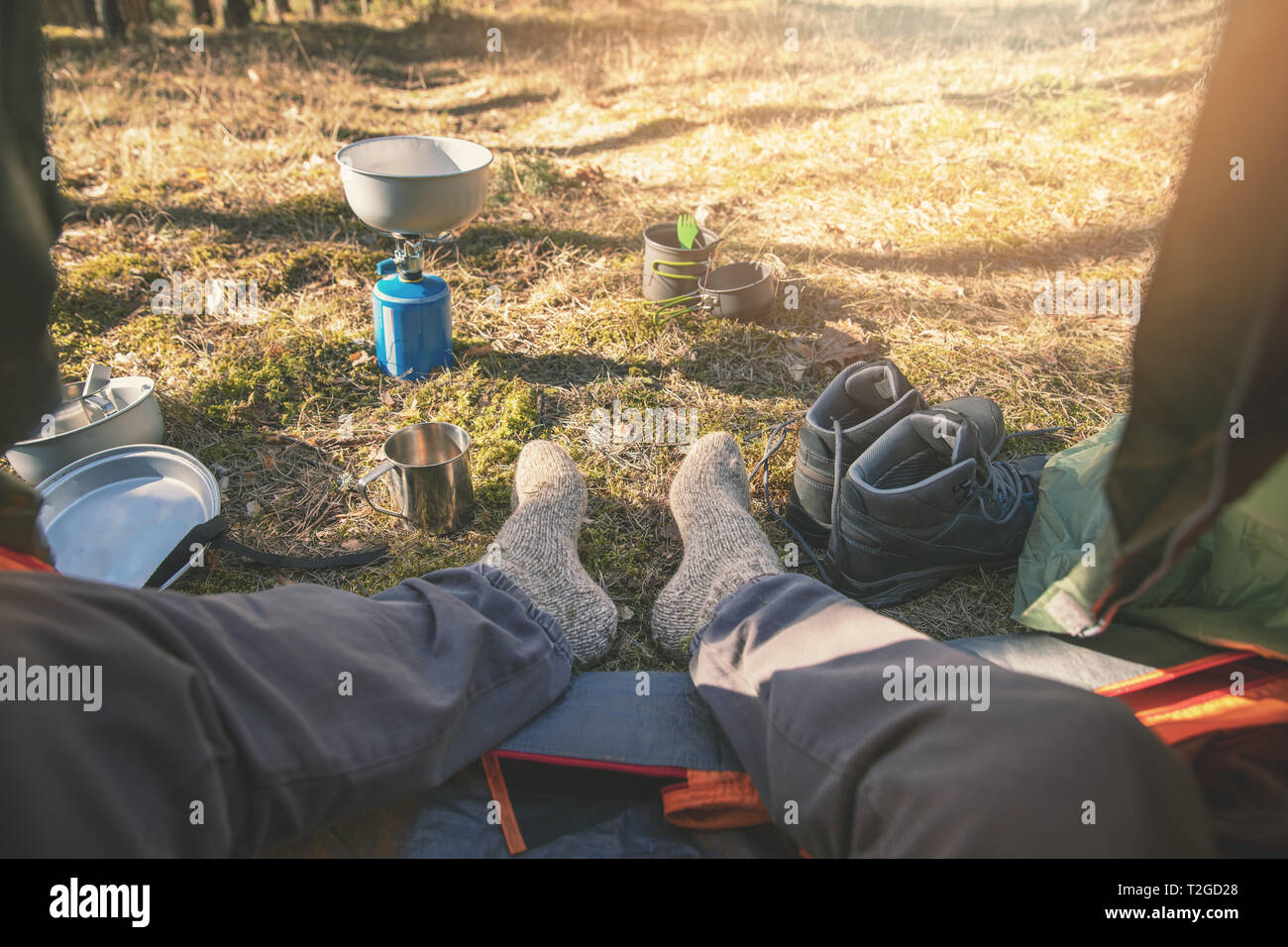 outdoor tourism - hiker feet with wool socks out of the tent Stock Photo