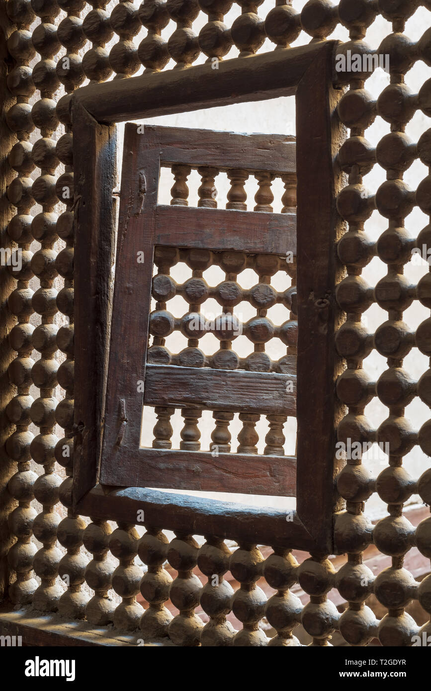 Wooden latticed window (Mashrabiya) with one small swinging sash, Zeinab Khatoun historic house, Old Cairo, Egypt Stock Photo