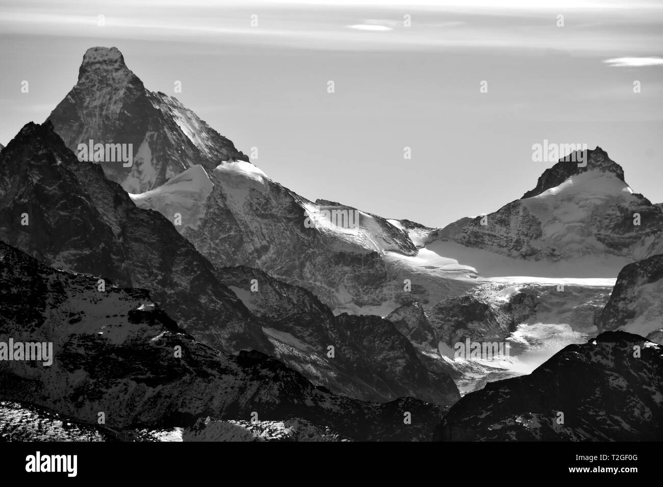 Monochrome of the Matterhorn (left) and the Dent d'Herens in the Southern Swiss Alps between Zinal and Zermatt. Caught in the evening sun Stock Photo