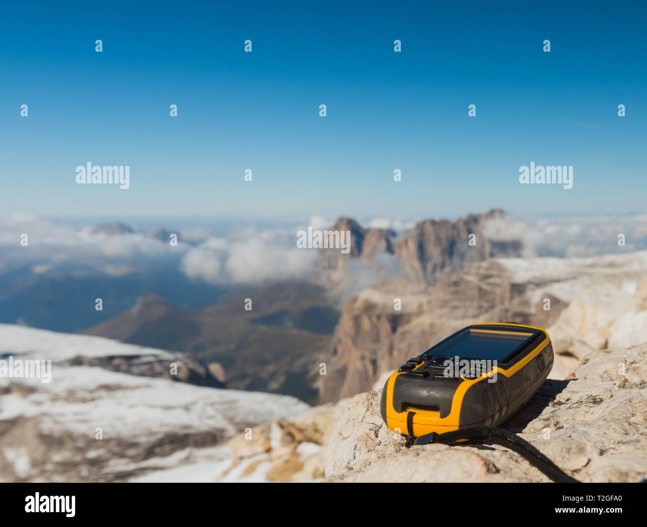 GPS navigator in hand against Dolomites Alps Stock Photo
