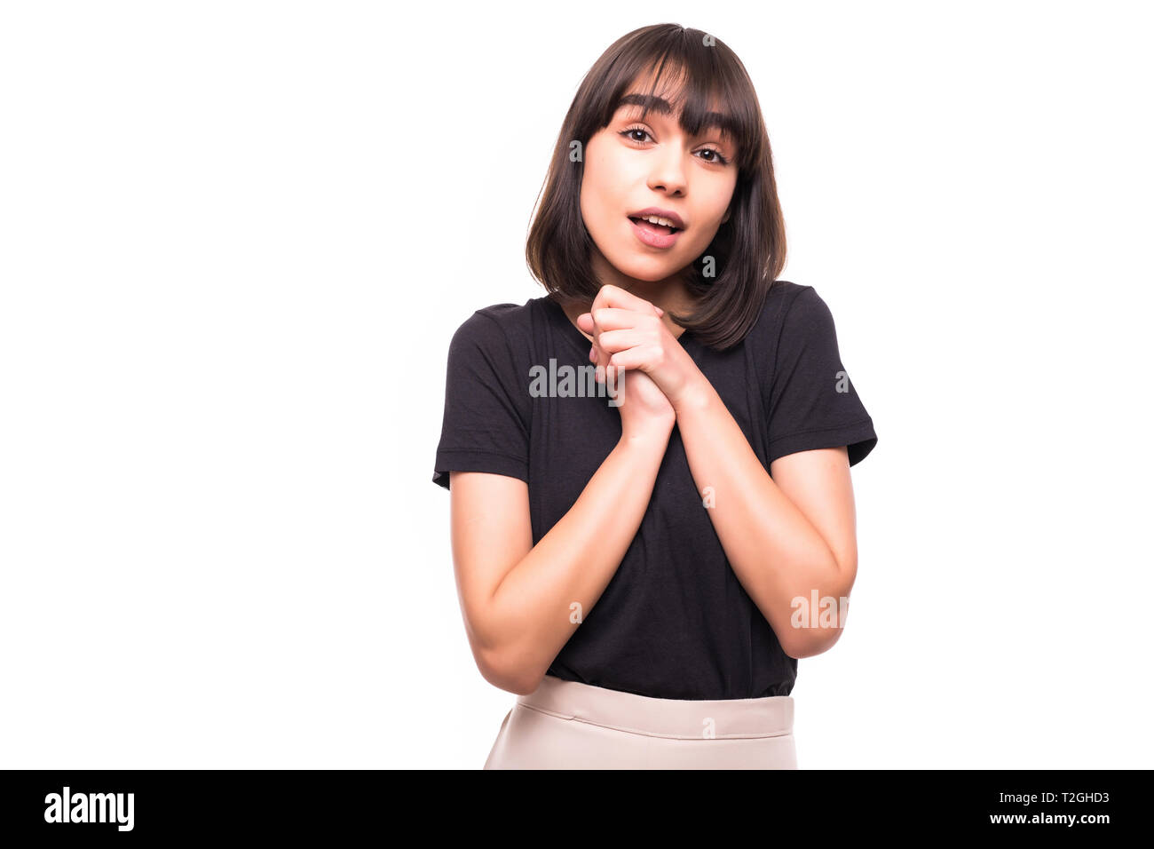 young-woman-showing-her-heartfelt-gratitude-and-thanks-clasping-her-hands-to-her-heart-with-a-pleased-smile-on-white-background-T2GHD3.jpg