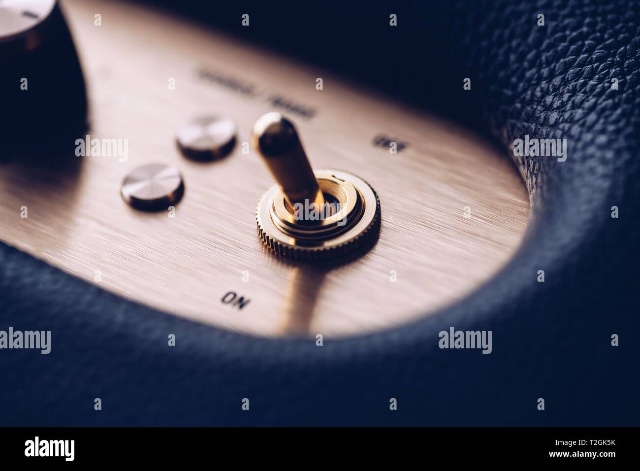 On and off metal gold plated switch on music amplifier Stock Photo - Alamy