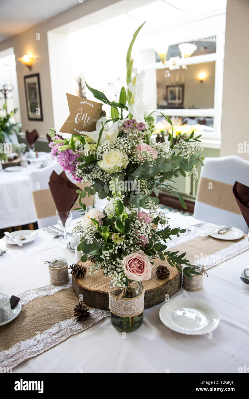 Floral wedding day decorations on tables at the wedding reception Stock