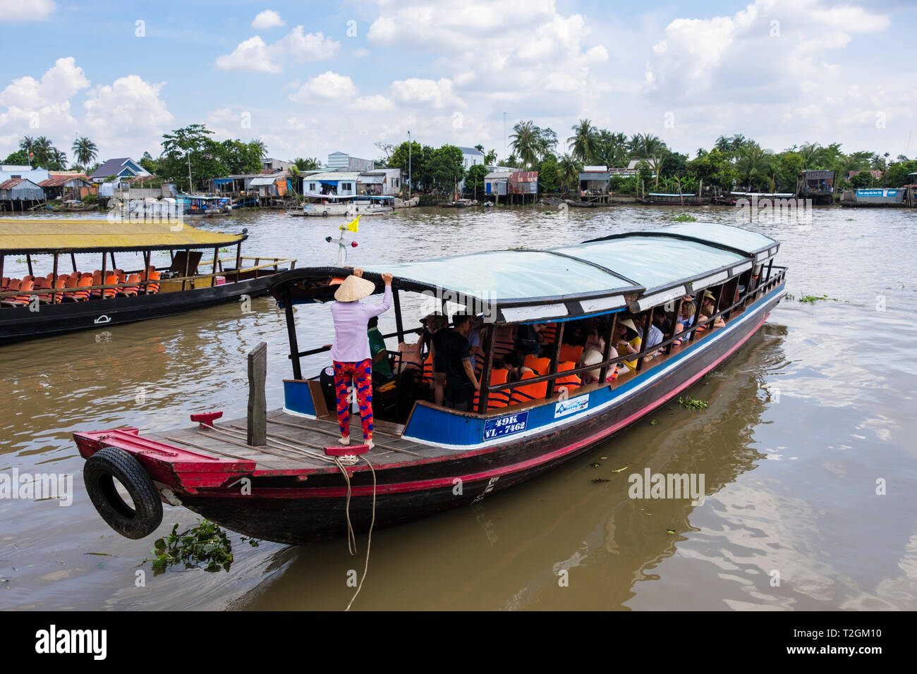 Tourists in traditional boat for river trip in Mekong Delta. Cai Be, Tien Giang, Vietnam, Asia Stock Photo