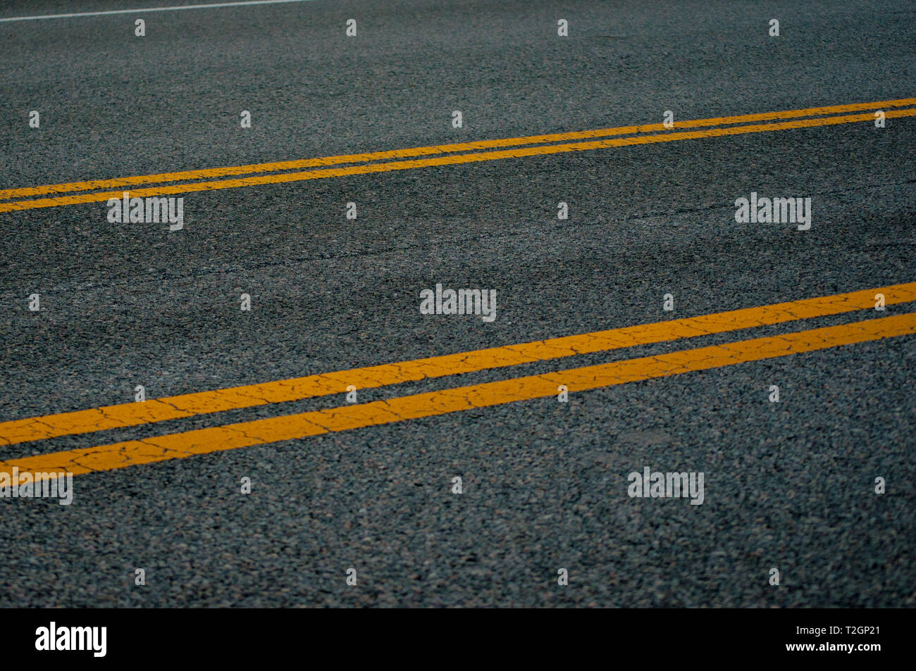 Yellow dividing lines on highway Stock Photo