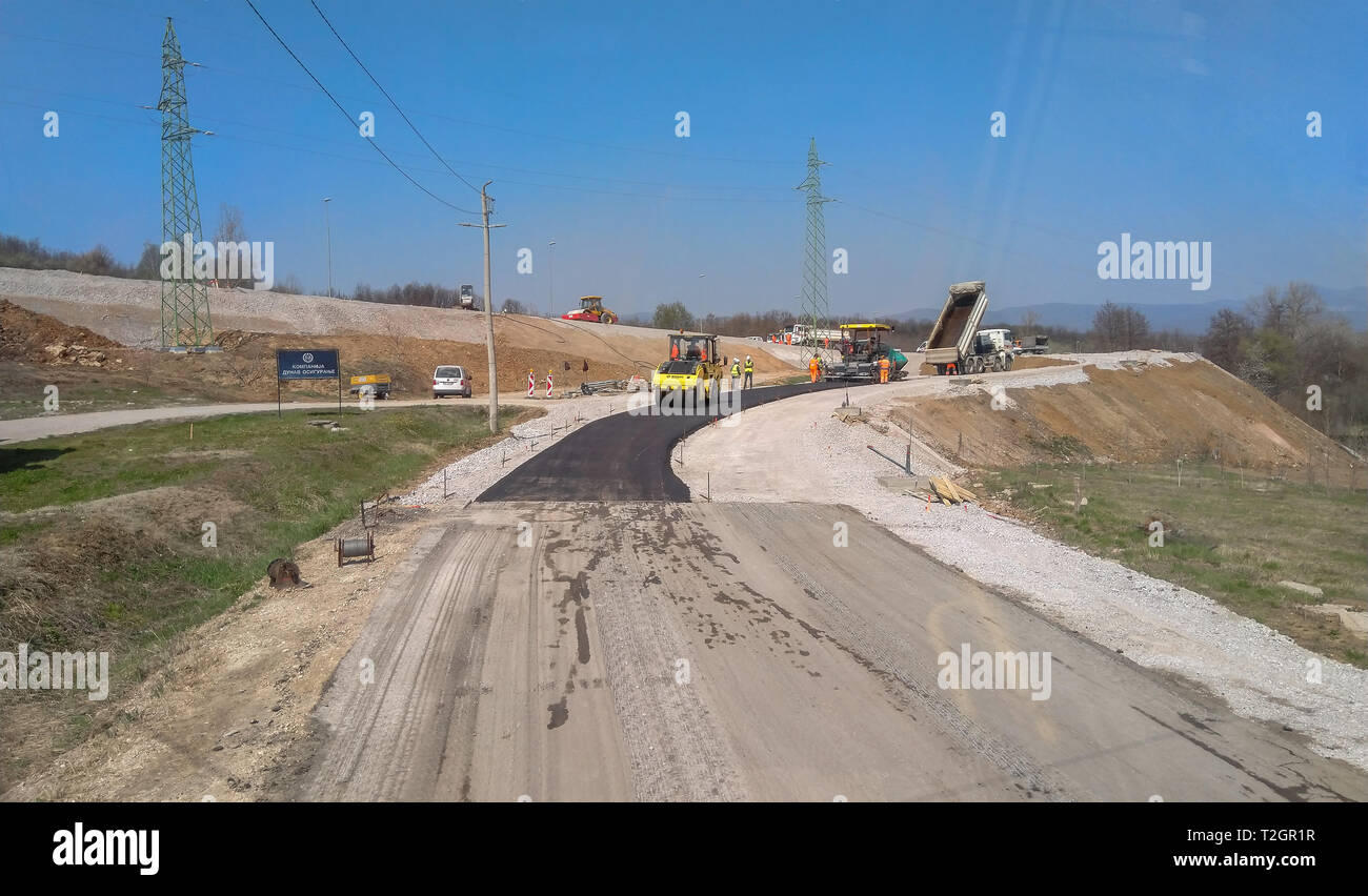 Boljevac, Serbia - April 02, 2019: Asphalt machines set up on the route and workers ready to start ascending the road to Boljevac, Serbia Stock Photo