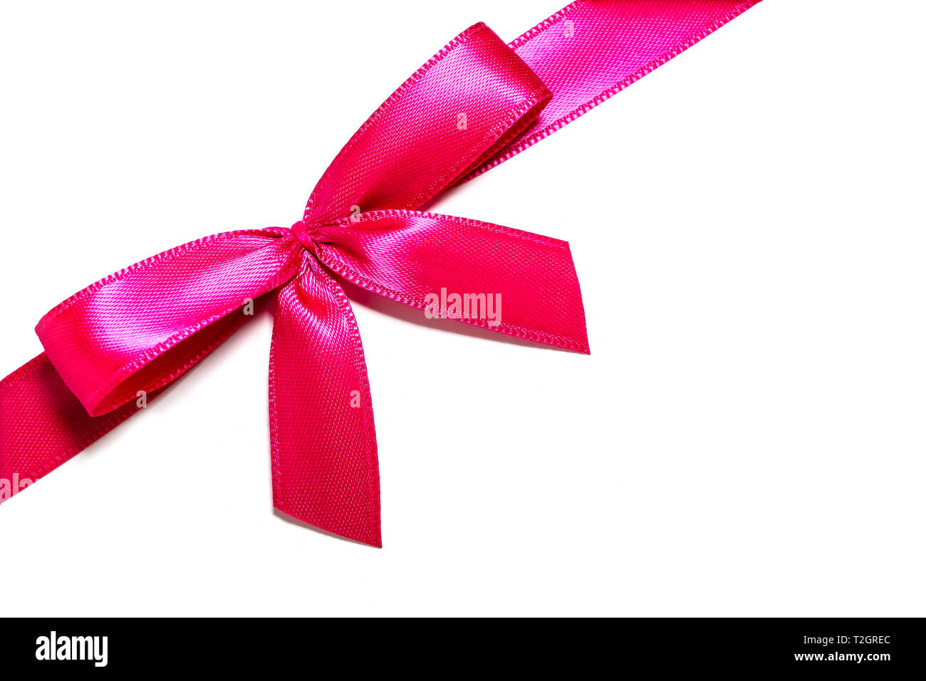 Pink gift ribbon bow. Pink red satin ribbon with knotted bow gift ribbon  wrap for Christmas present isolated cut out on simple plain white  background Stock Photo - Alamy
