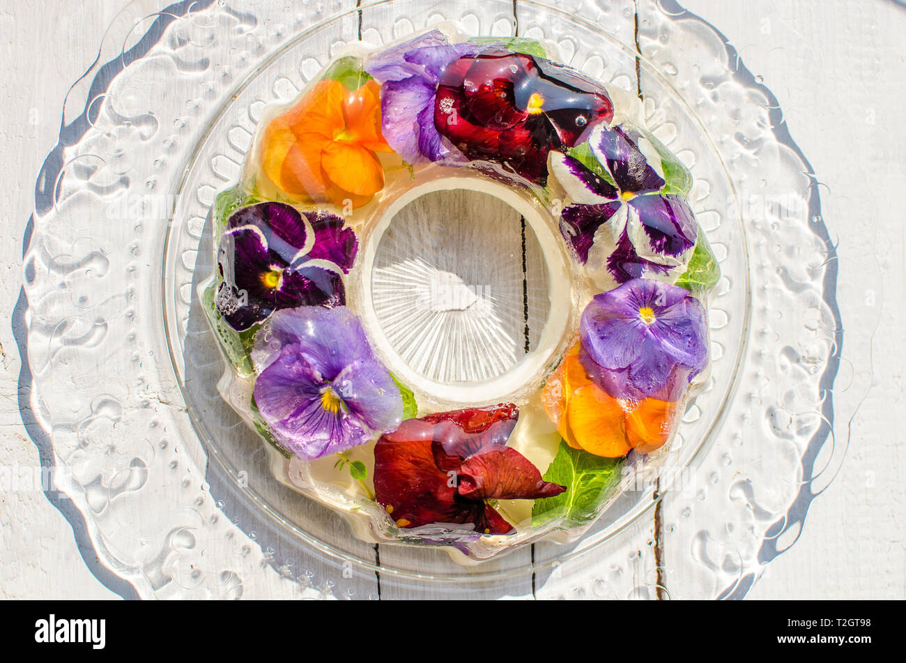 Spring jelly cake with flowers on the bright background Stock Photo