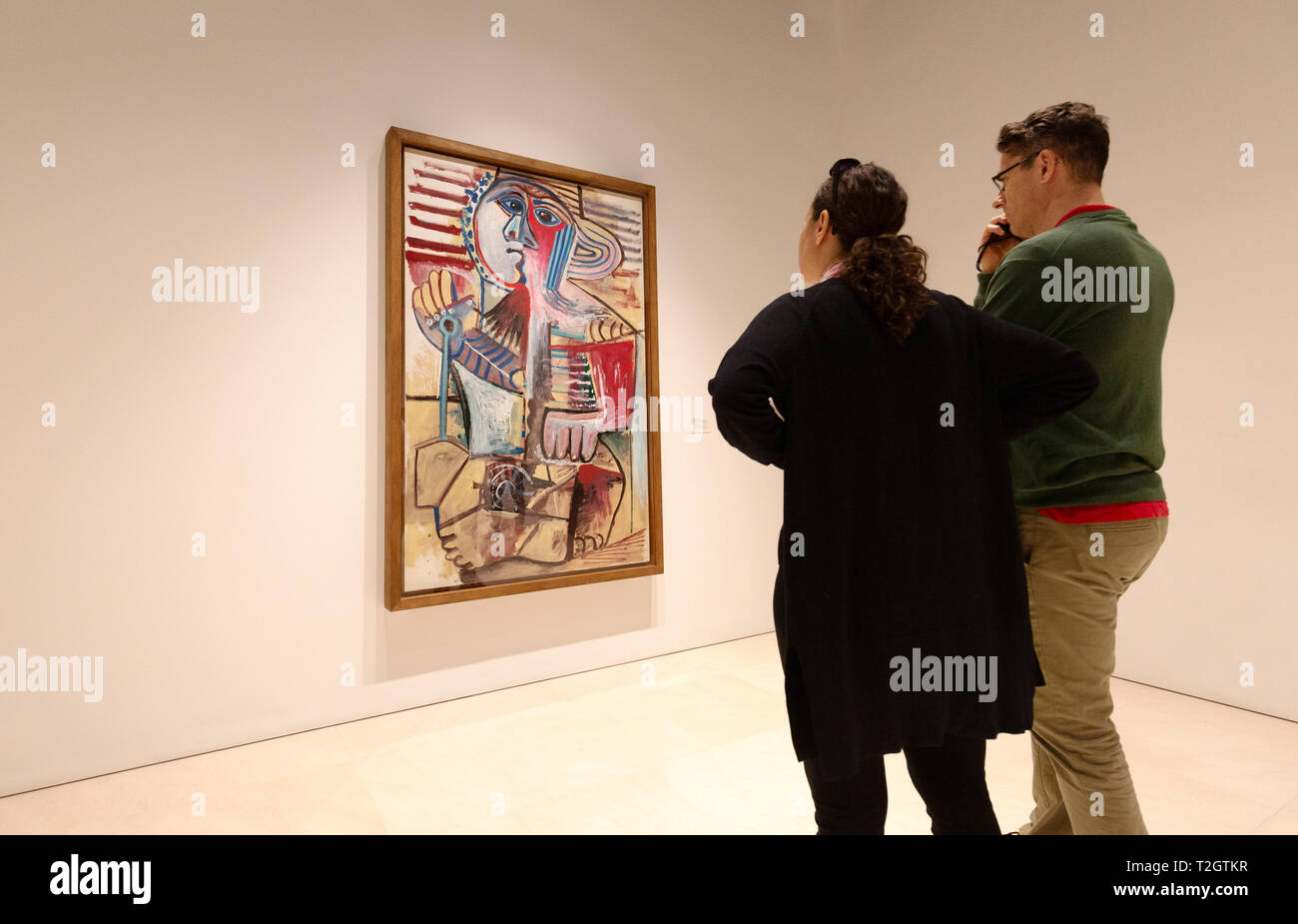 Malaga Museum of Picasso - people looking at the Picasso painting 'Child with a shovel, Mougins 1971', Malaga, Andalusia Spain Stock Photo
