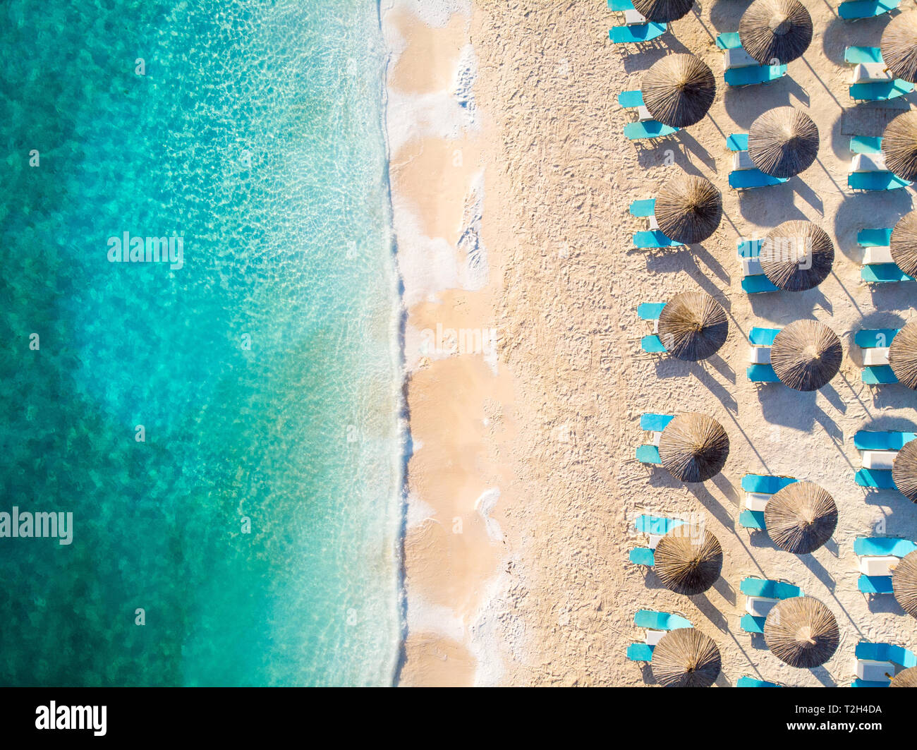 Relaxing beach top down view with chairs and umbrellas Stock Photo