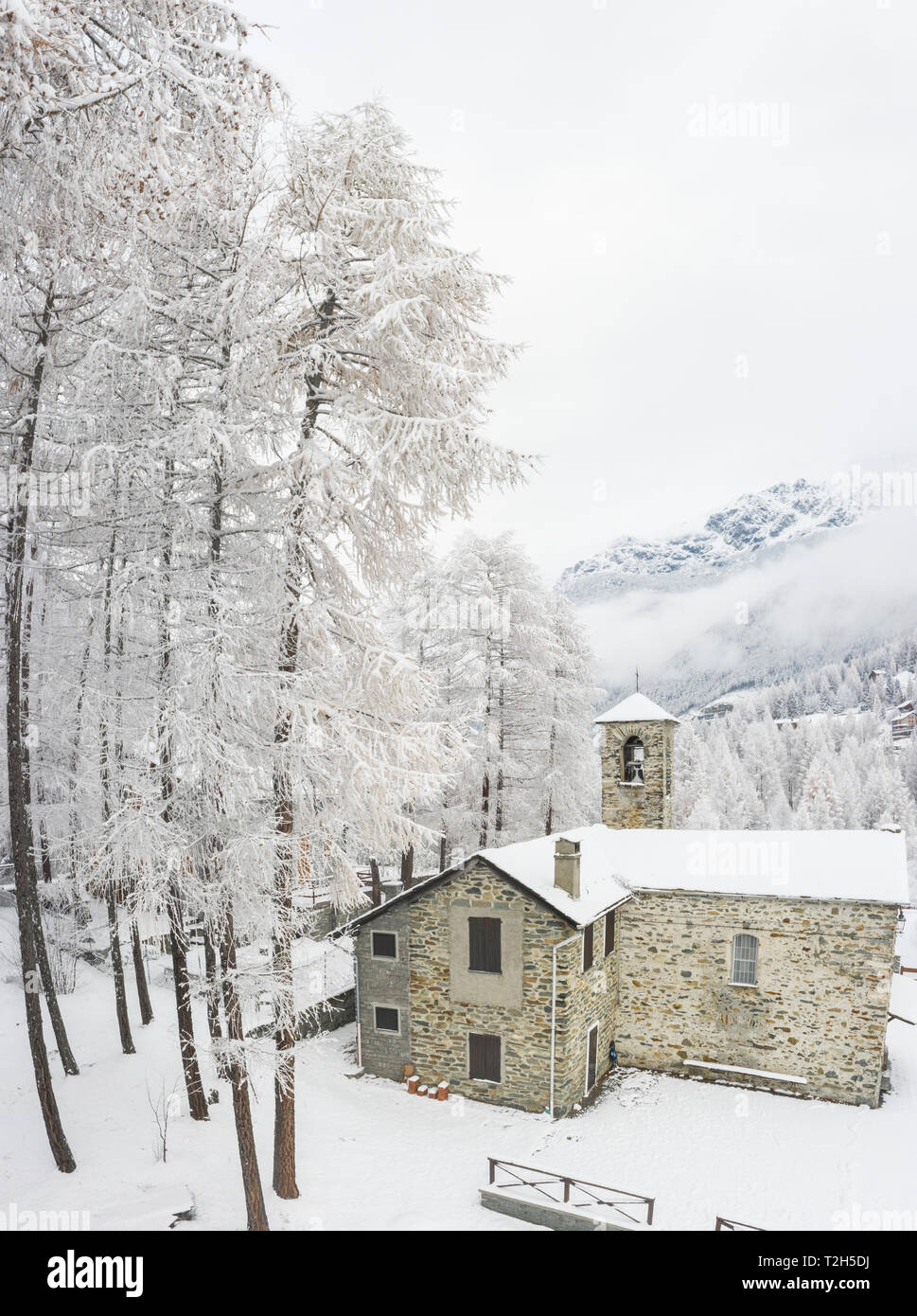 Stone church during winter in San Giuseppe, Valtellina, Italy, Europe Stock Photo