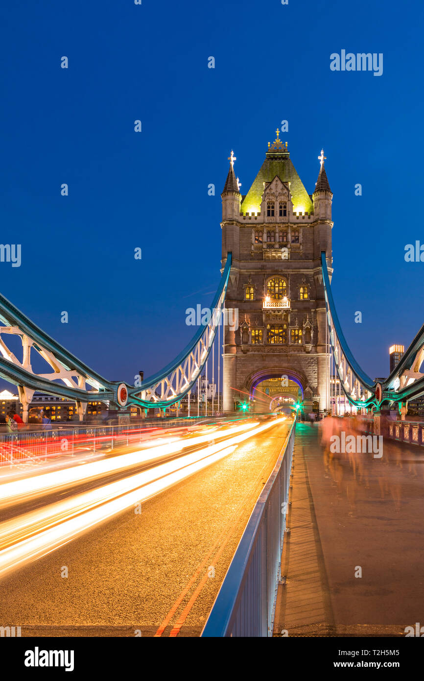 Light trails on Tower Bridge at sunset in London, England, Europe Stock ...
