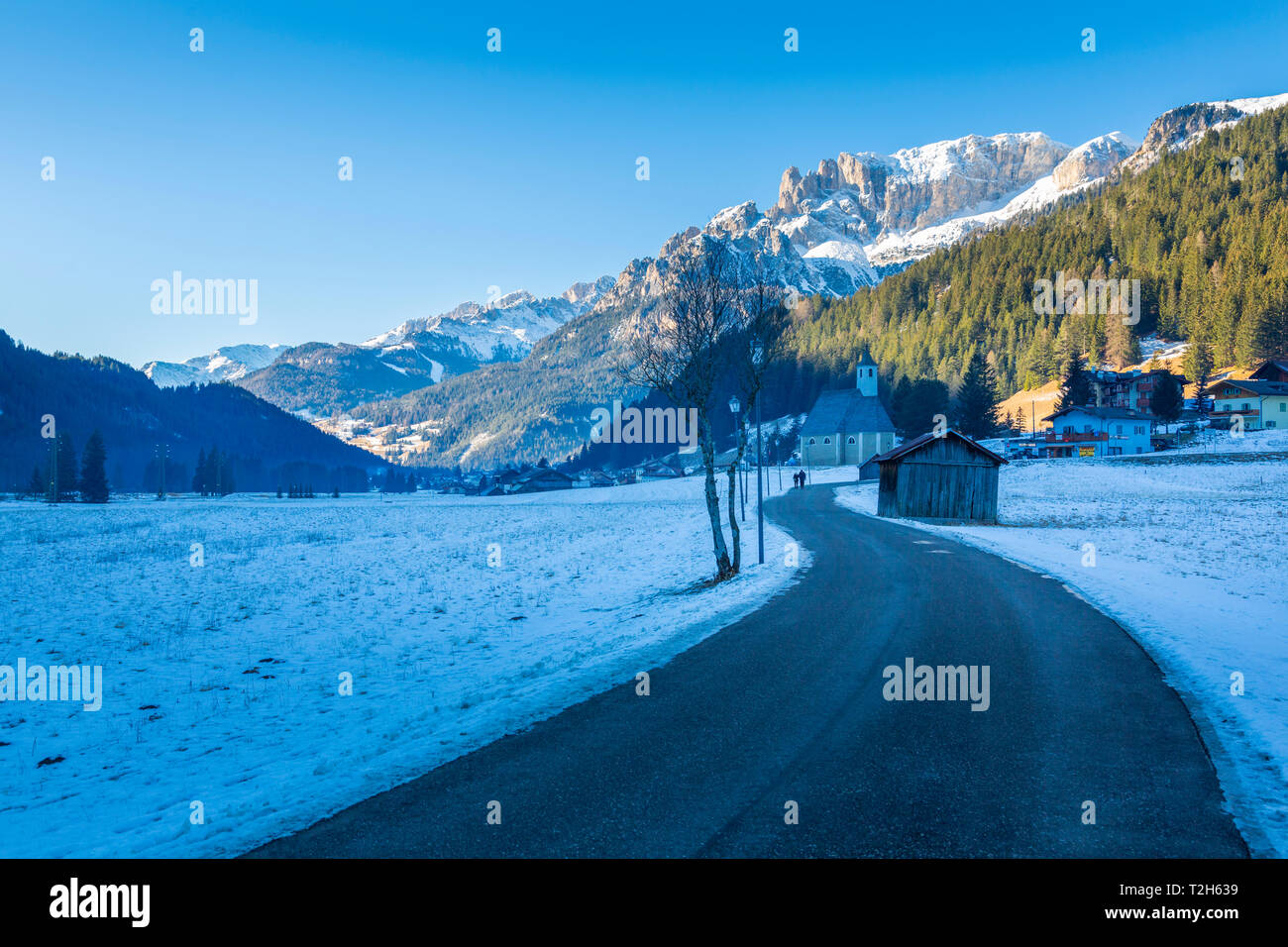 Road through snow under Dolomites Italy, Europe Stock Photo