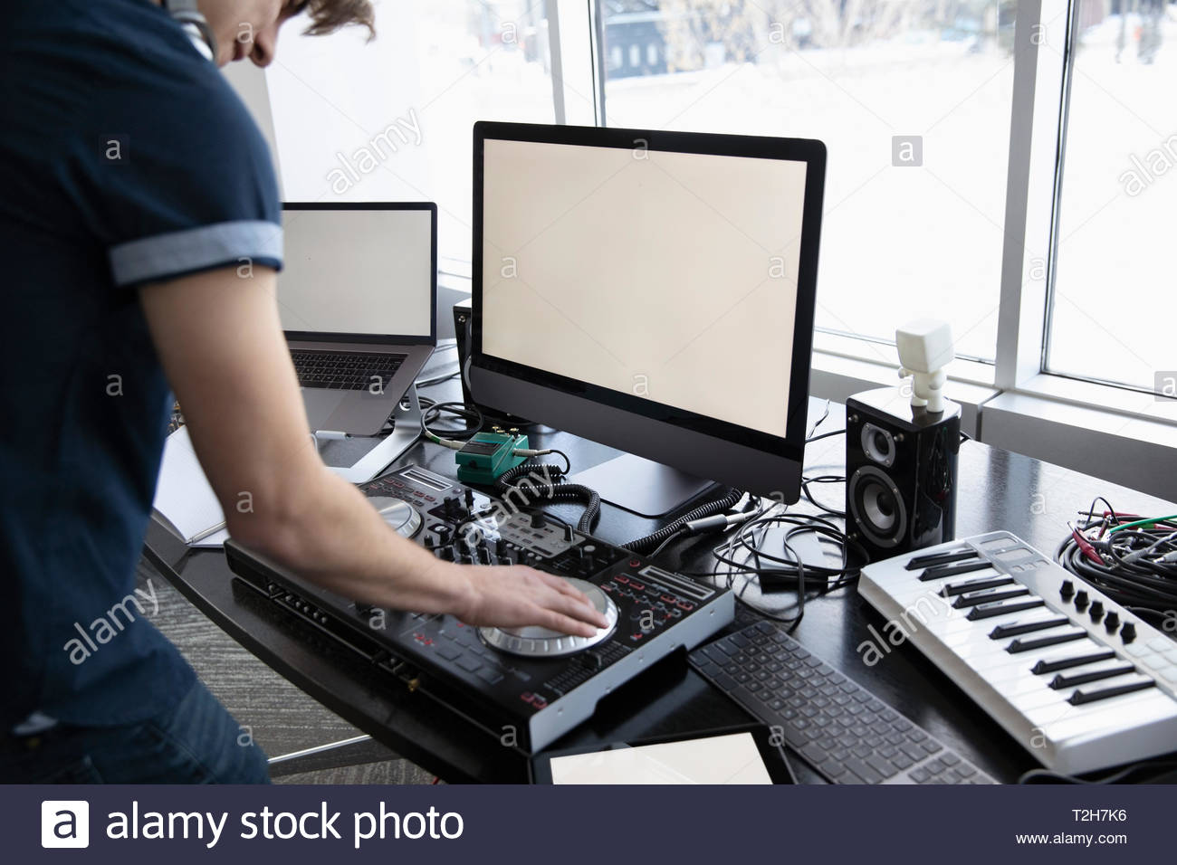 DJ using digital mixing tables at desk Stock Photo Alamy
