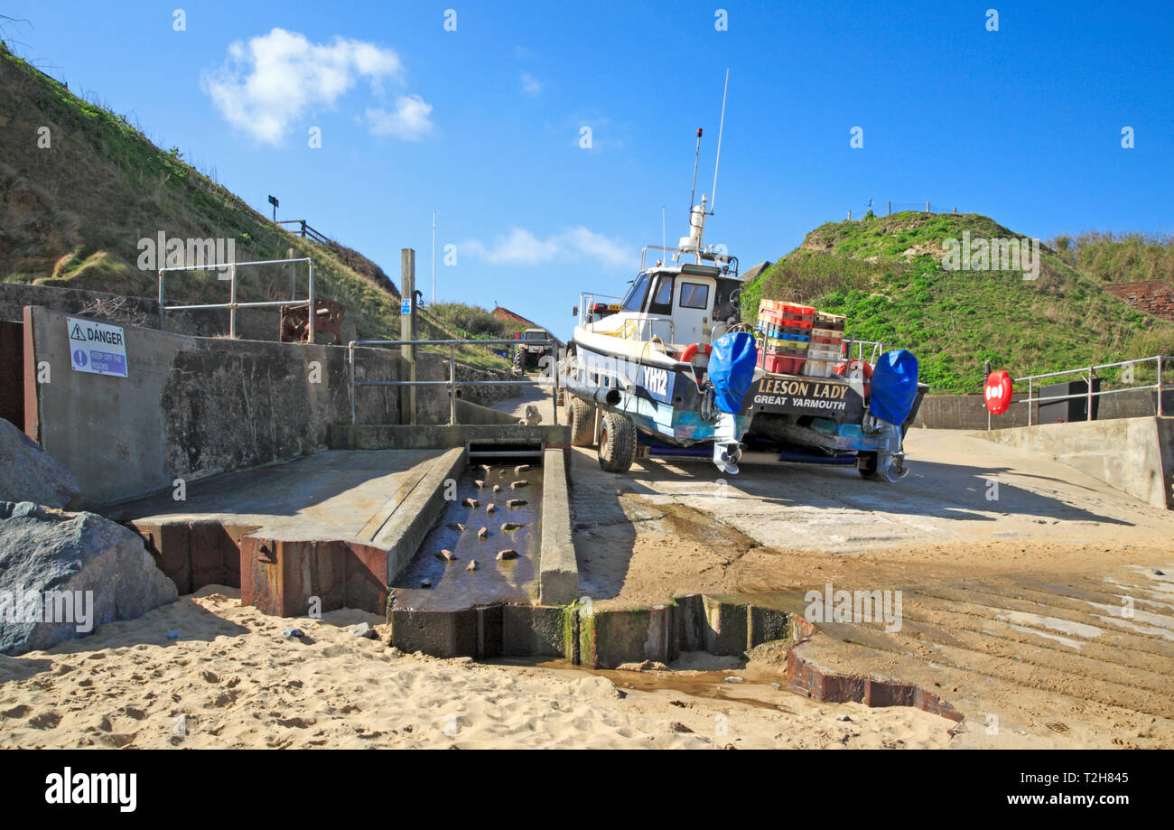 Local fishing boat and tractor off the beach on the access gangway on